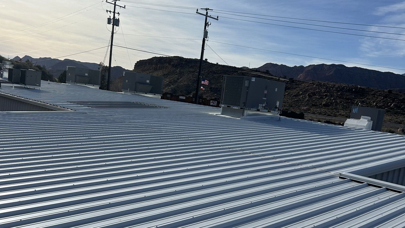 Rooftop packaged HVAC units on a commercial building in southern Utah with red rock mesas on the horizon