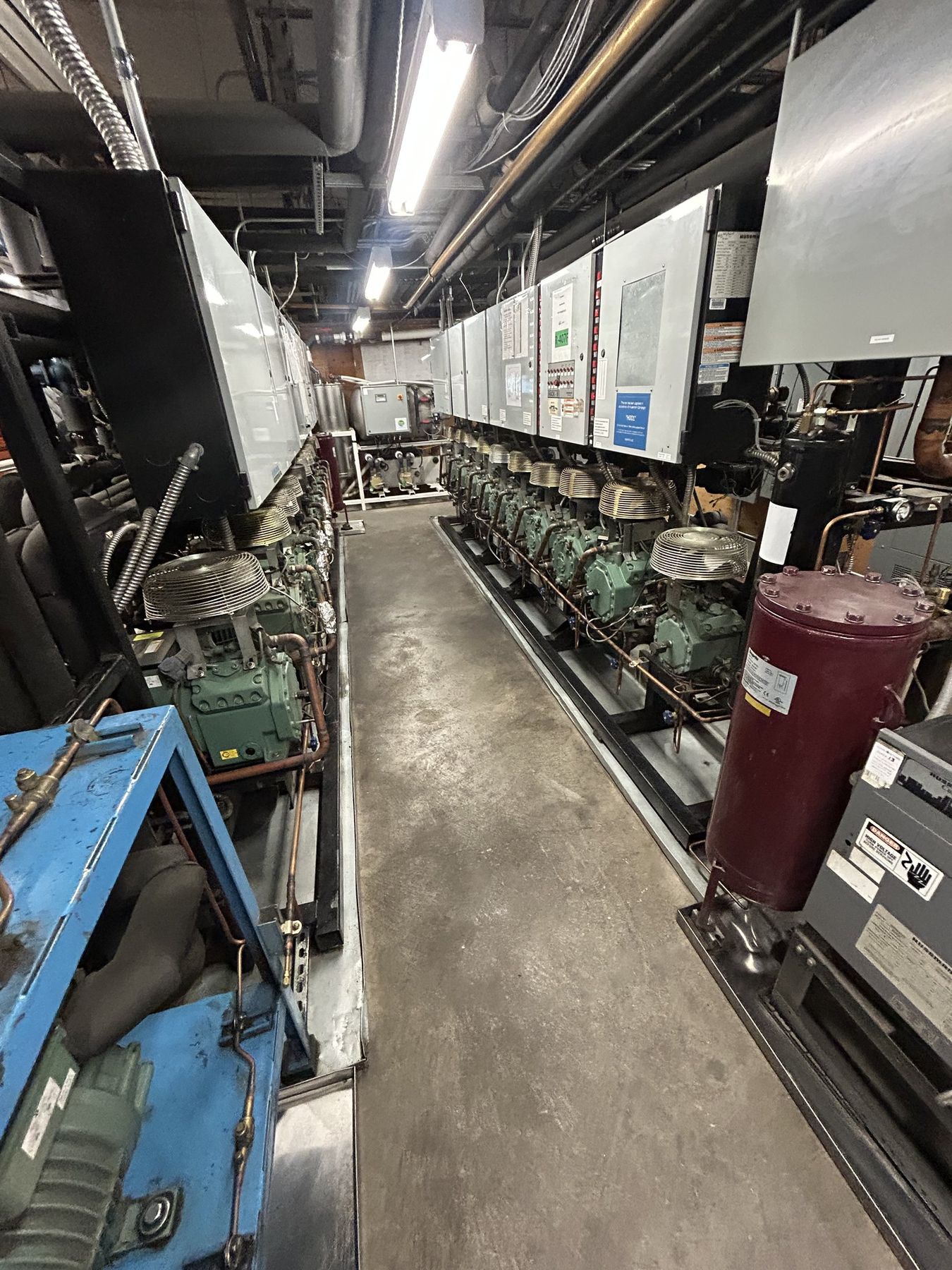 Long parallel refrigeration rack line running down a commercial machine room in St. George, Utah